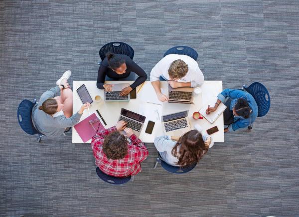 Creative Writing program students, birds-eye view of table and students