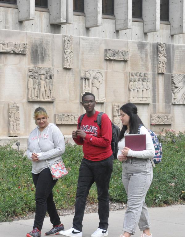 Three students walking on campus