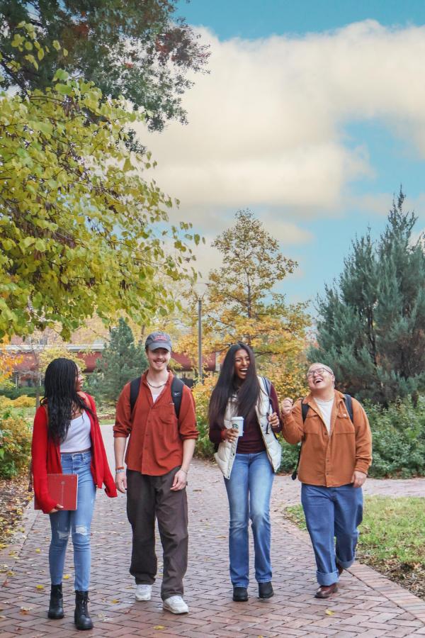 Four students walking on campus
