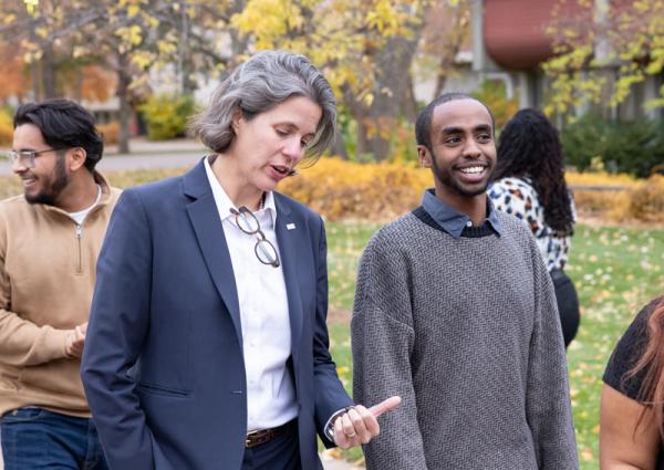 President Hostetter walking and talking with Mo Med